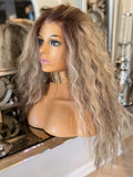Mannequin head with a long, wavy wig on a decorative background